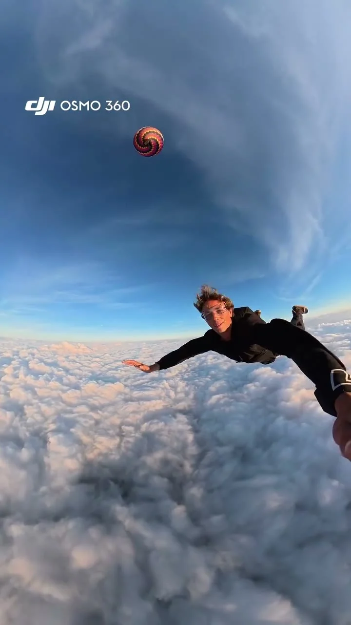 Source preview of a skydiver above the clouds with a distant hot-air balloon and DJI Osmo 360 camera branding in the upper left