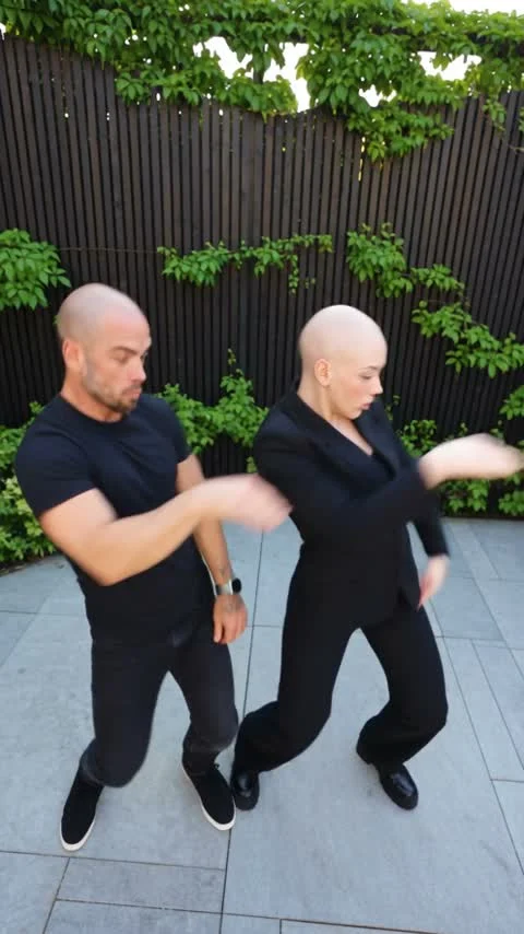 Two performers in the source Smalltown Boy courtyard scream-dance scene