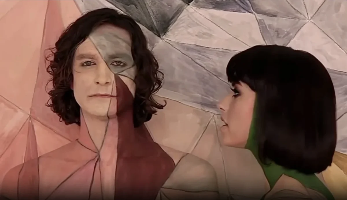 Two performers against the geometric painted wall in the source duet